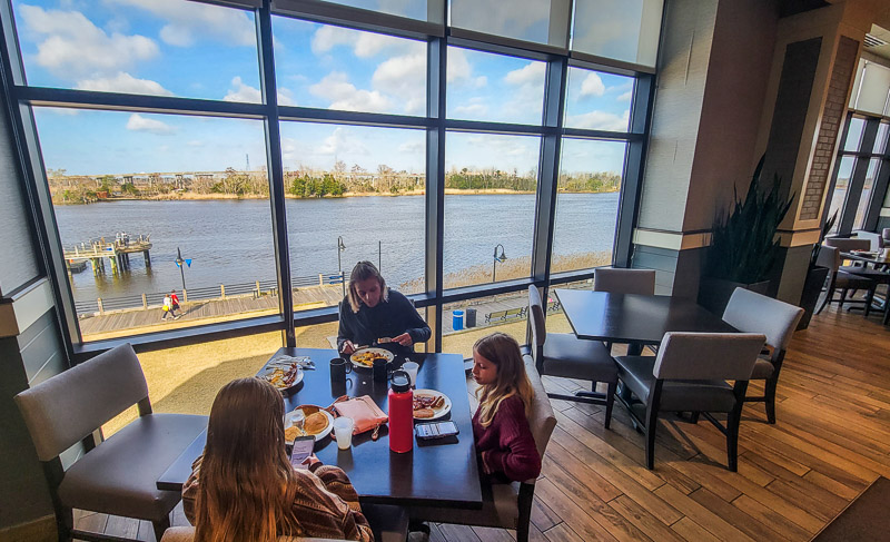 family eating breakfast with cape river views 