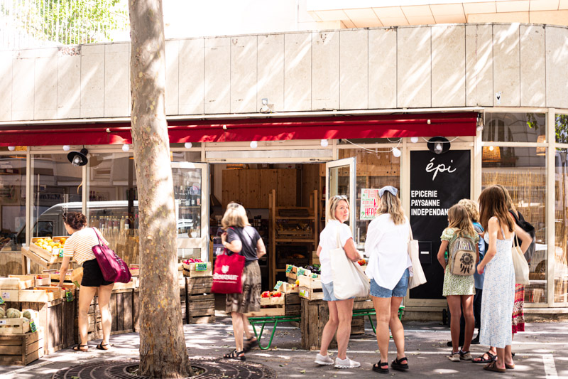 people standing outside epi grrocery store in montmartre