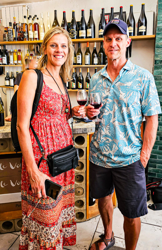 caz and craig posing with glass of wine at Les Naturistes