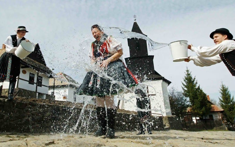 people throwing buckets of water on each other