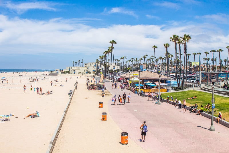 people walking along ocean strand