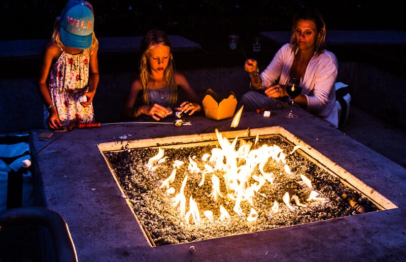 family roasting s'mroes over kimpton firepit