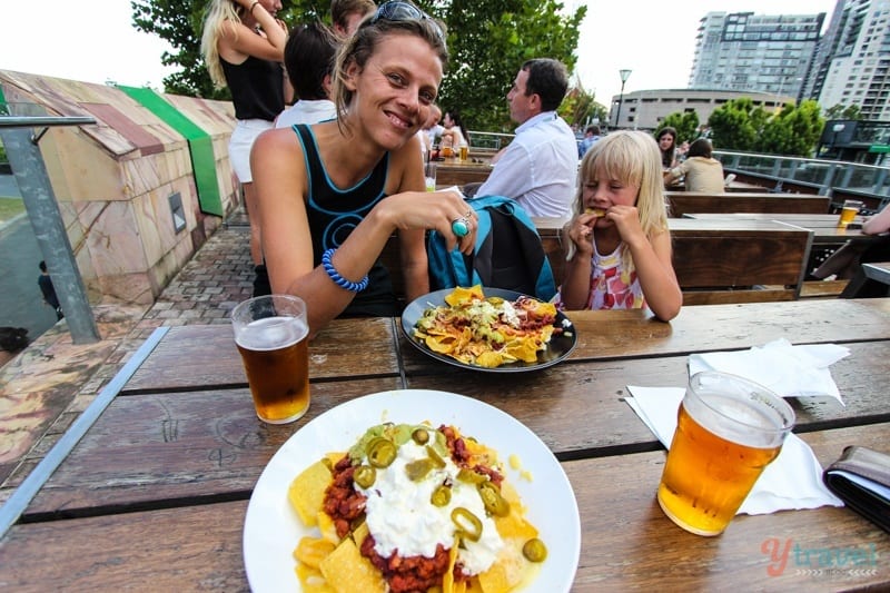 woman and child eating nachos at Transport Hotel, Melbourne, Australia