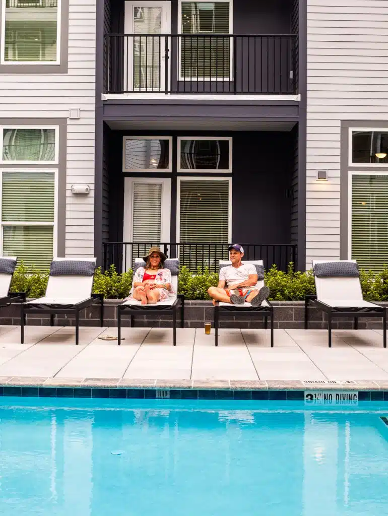 man and woman on pool lounges