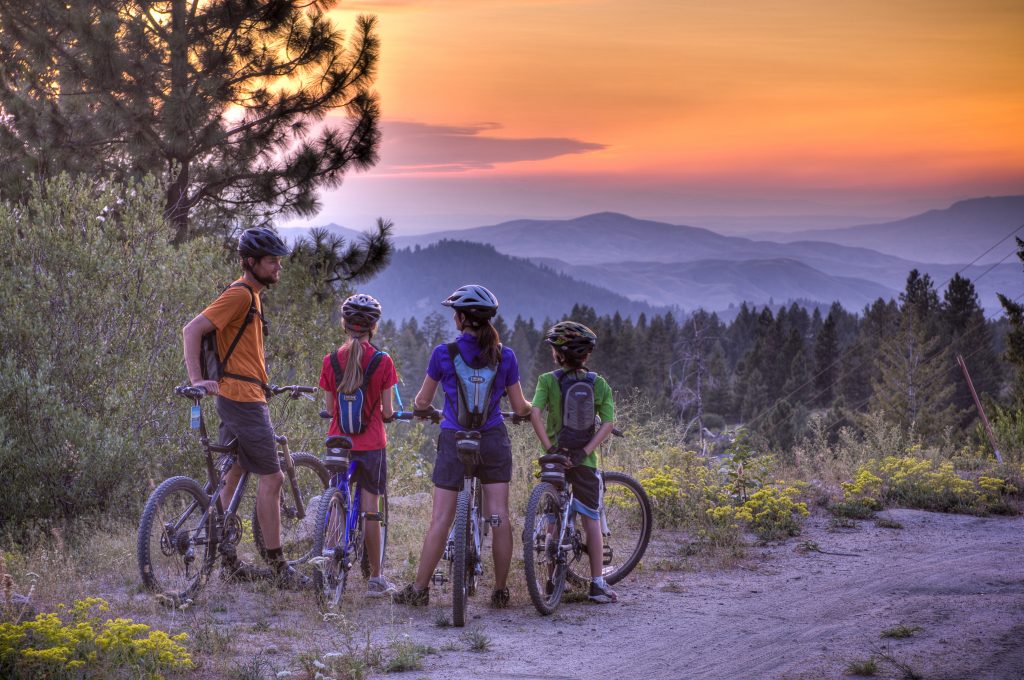 mountain bikers looking at sunset view at bogus basin boise