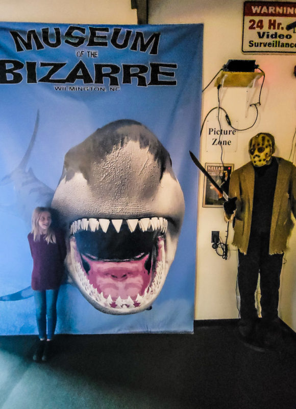 girl beside shark poster at Museum of the Bizarre, Wilmington