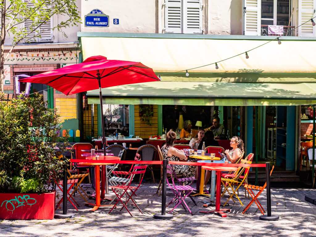 people sitting outside paris cafe