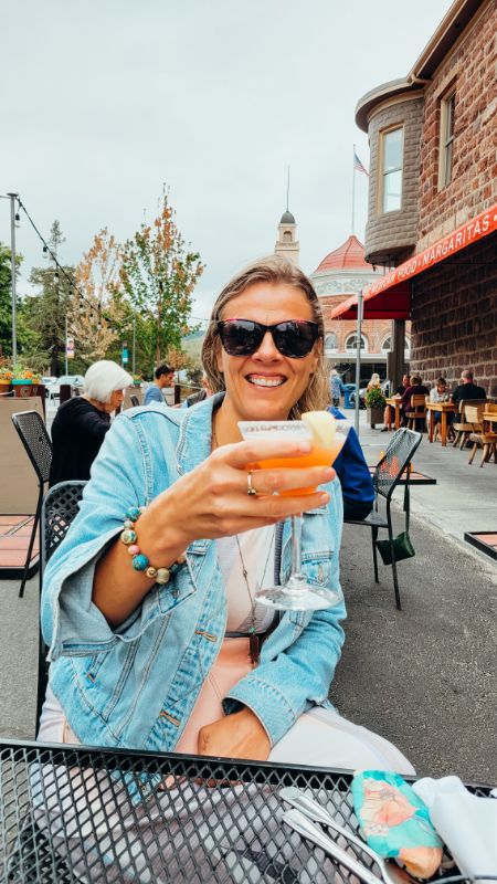 woman drinking a pomegranate margarita