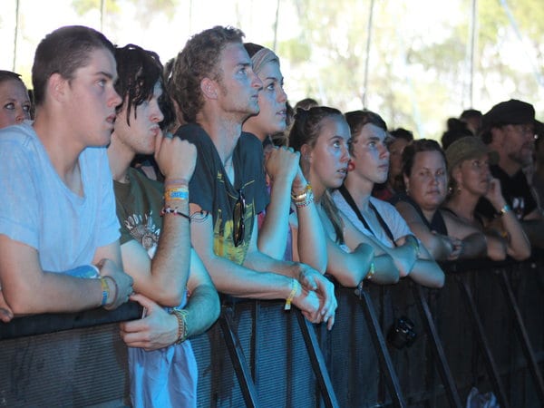 a crowd of people against a barricade