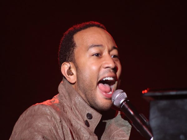 john legend singing into a microphone