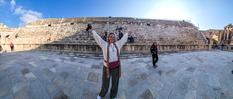 woman standing in front of an old wall