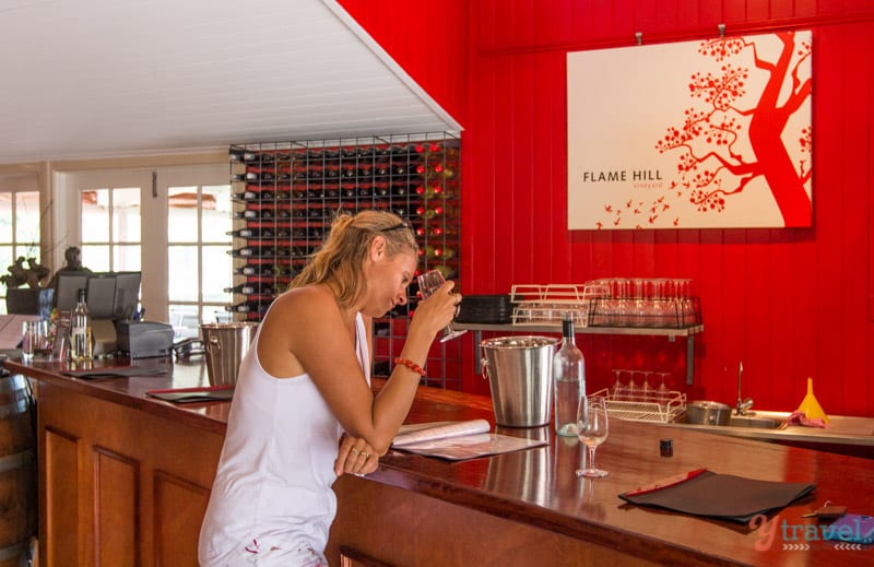 woman wine tasting at Flame Hill Vineyard - 