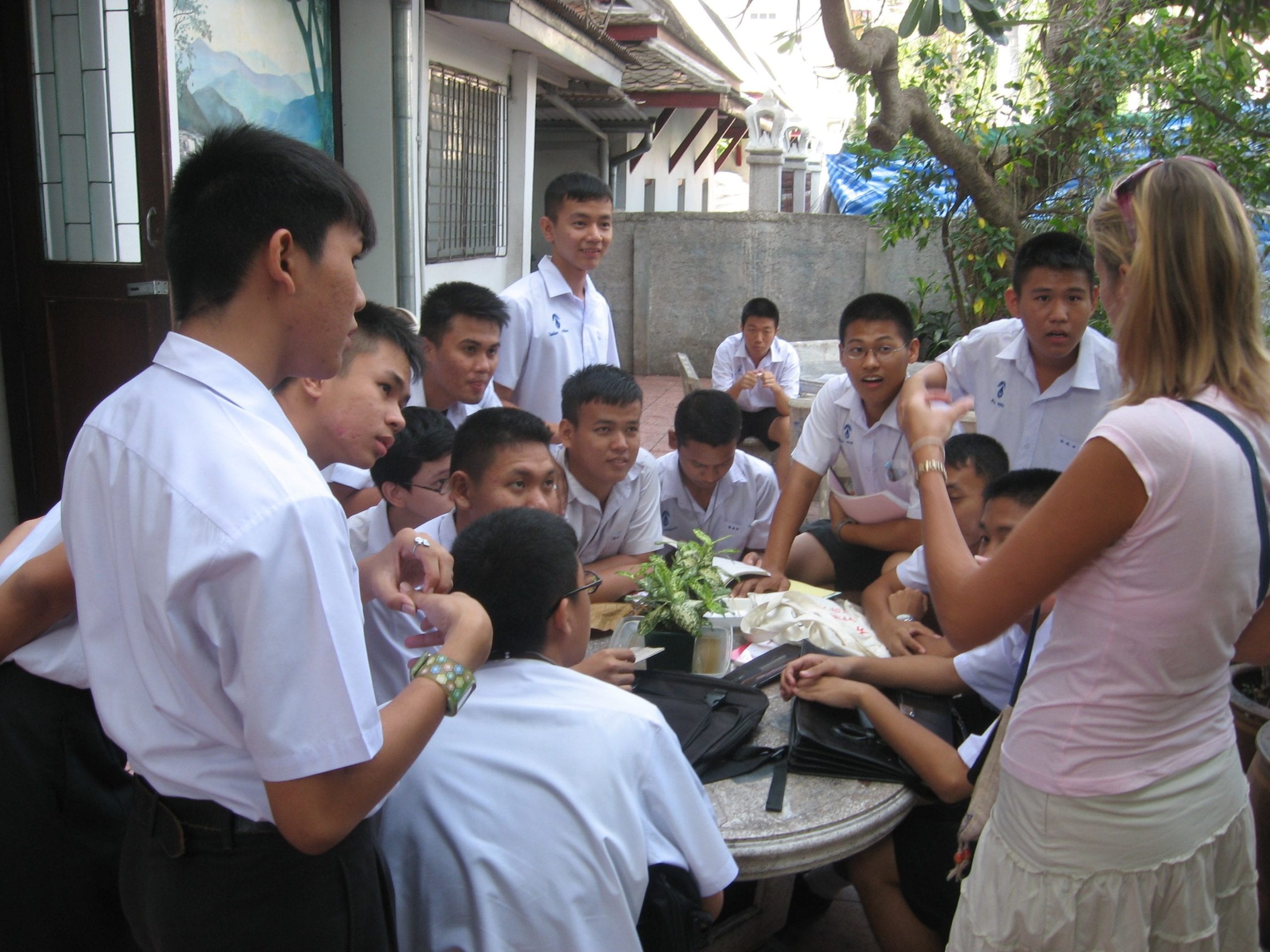 woman talking to thai students