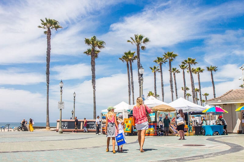 familu walking through huntington beach markets on pier