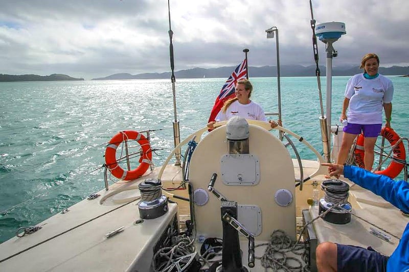 liz behind the wheel Sailing in The Whitsundays, Queensland, Australia