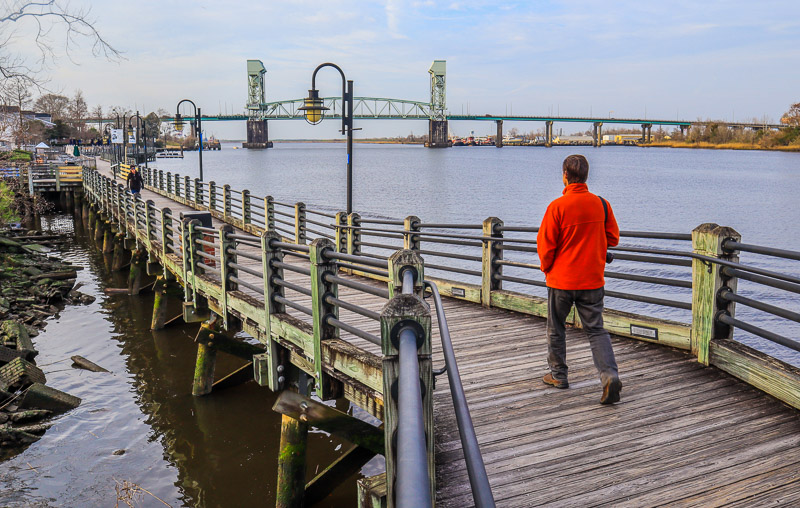 man walking on a board walk