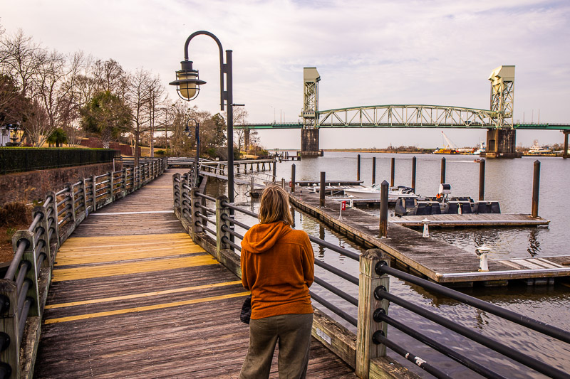 woman standing on a board walk