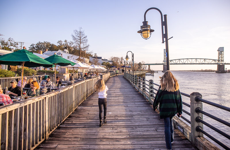 people walking on a board walk