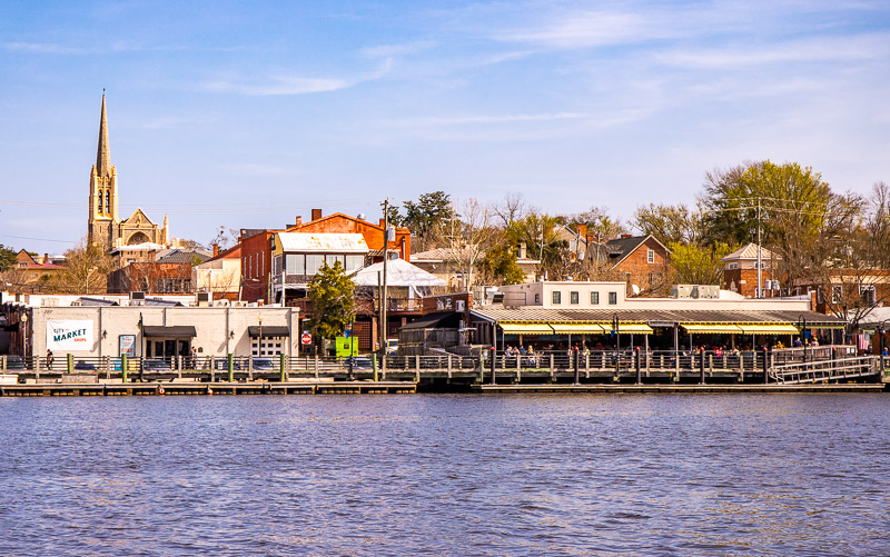 body of water with buildings in the background