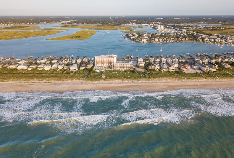 overview of a beach with hotels along the sand