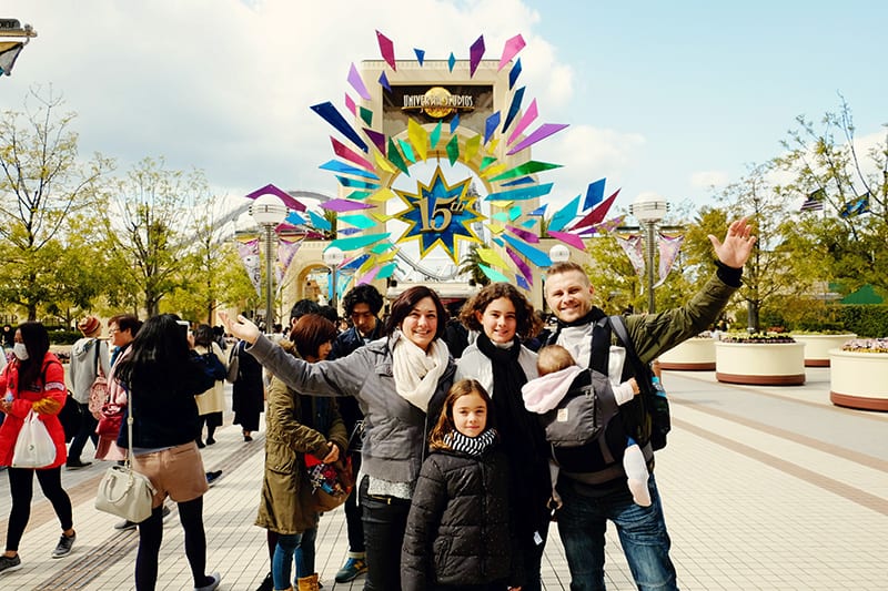 people standing in front of a large sign