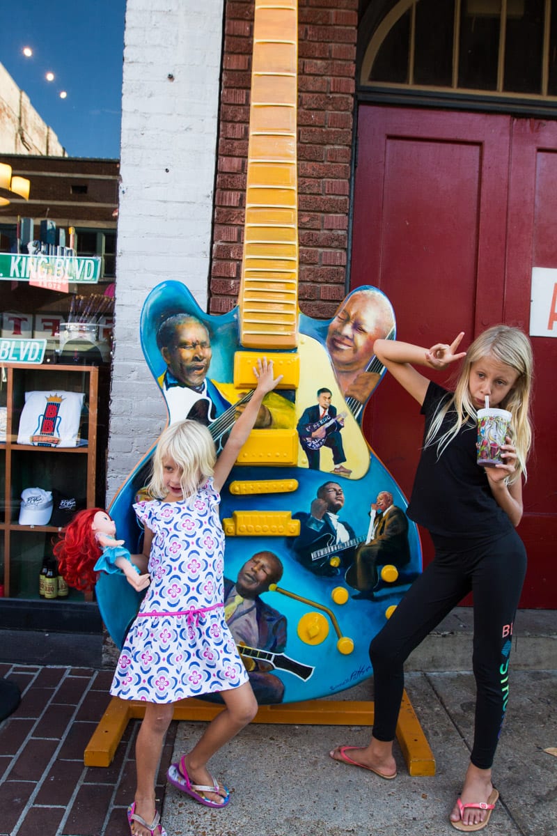 girls posing in front of giant guitar Beale Street, Memphis - 