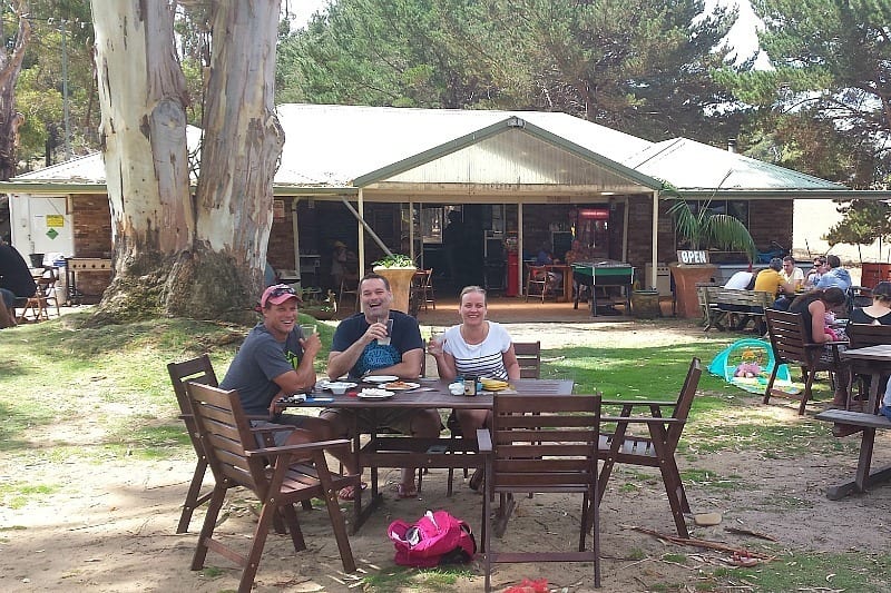 people sitting at a wooden table