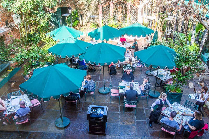 people eating in courtyard of Brennan's Restaurant