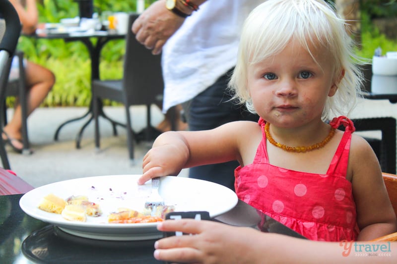 girl eating food at table