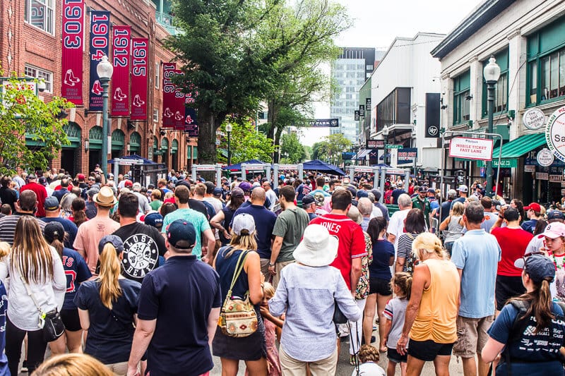 a crowd of people walking down a street