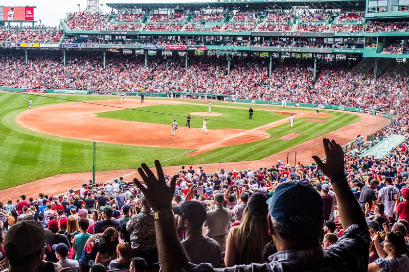 A crowd of people watching a baseball game