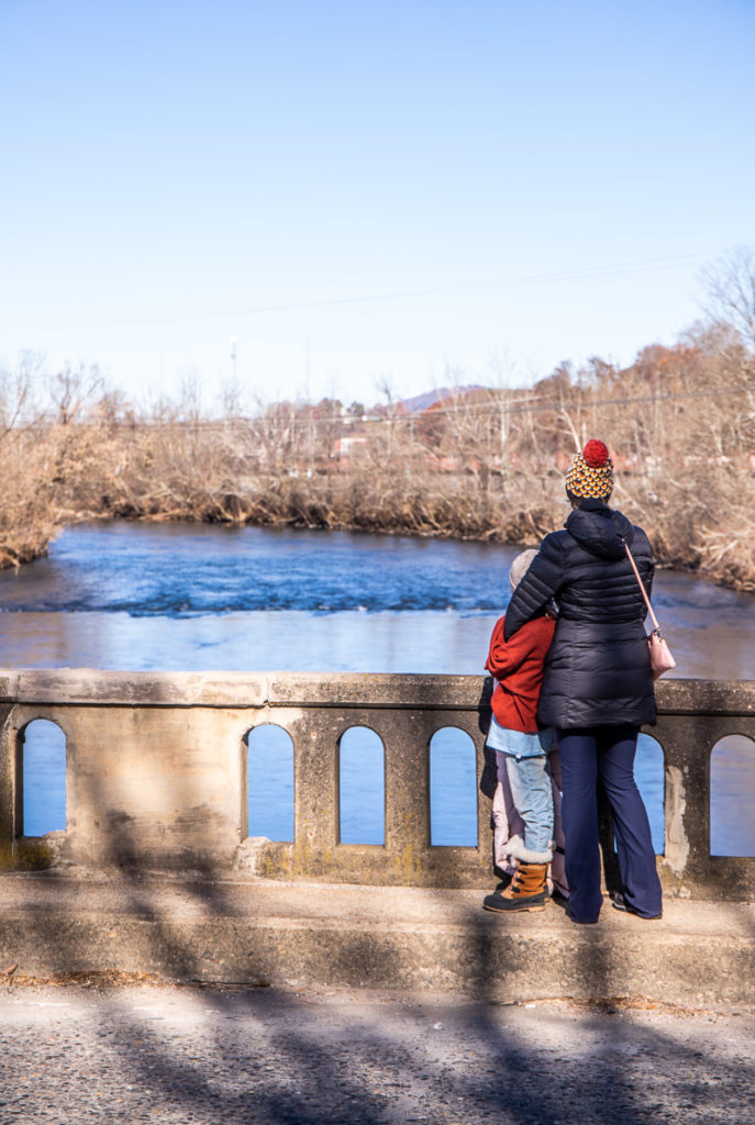 woman and child looking at the french broad river in asheville