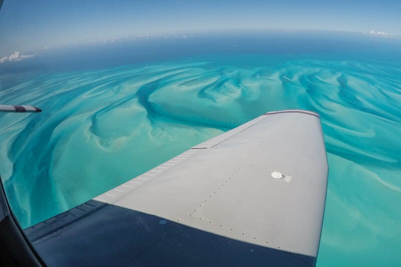 plane wing over the ocean