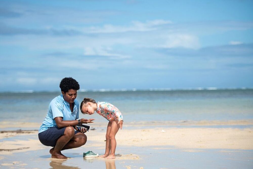 fijian woman and child on beach