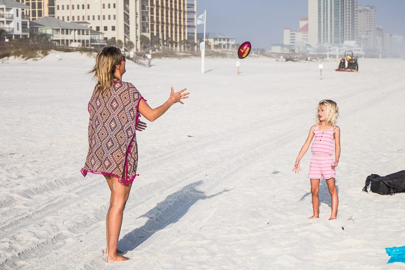 mother and child throwing a football on Orange Beach, Alabama