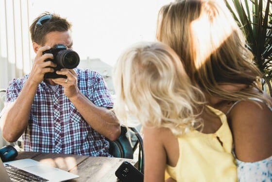 man taking photo of family