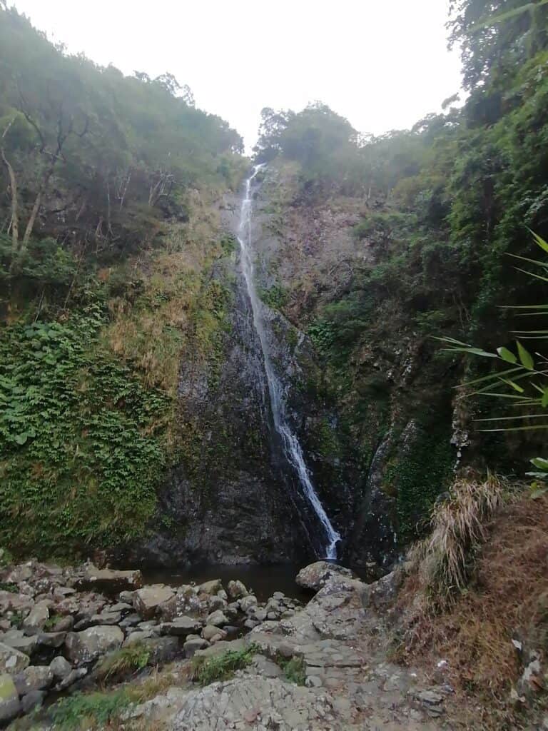 trickling waterfall spilling over cliff face