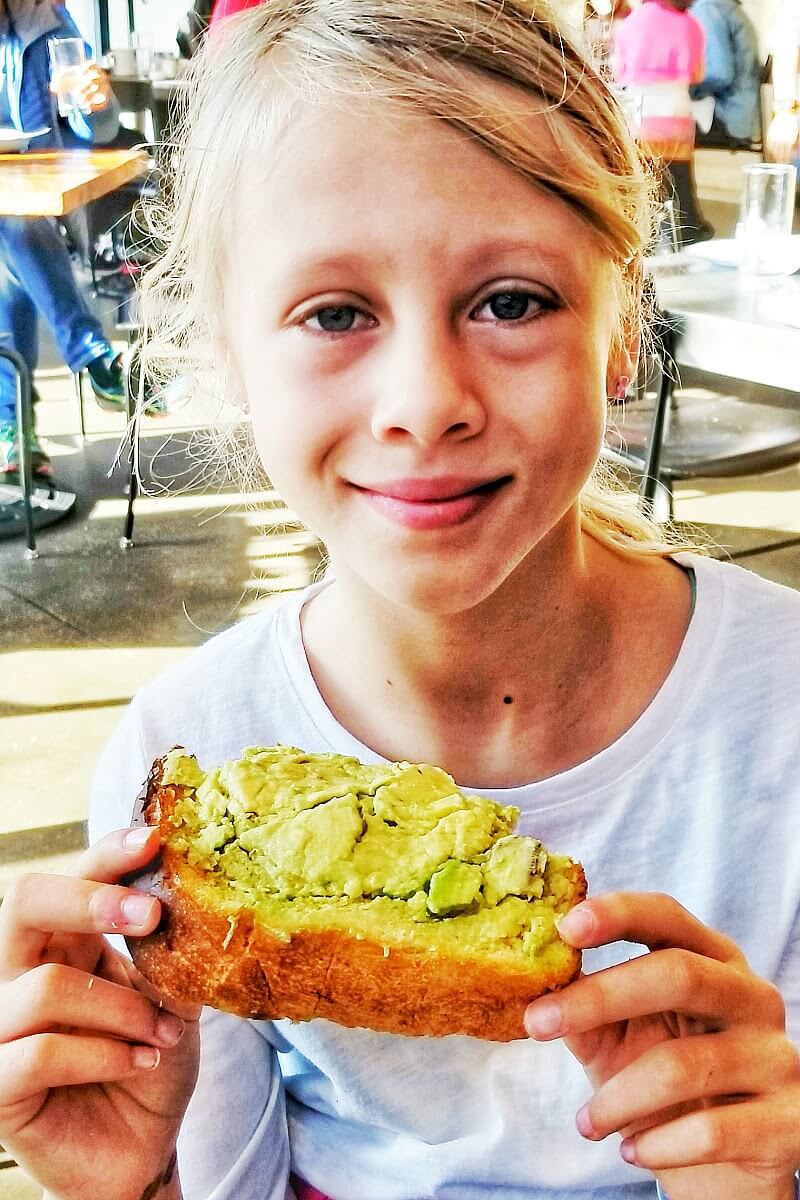 girl eating smashe3d avo toast